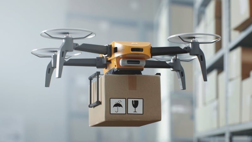 An unmanned aerial vehicle (UAV) delivers a cardboard box